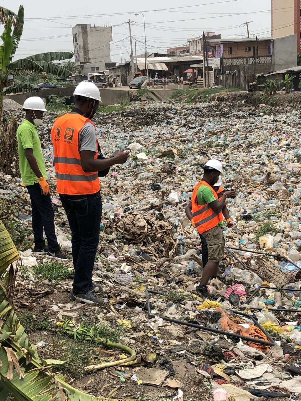 WasteAid team surveying a river full of plastic in Douala Cameroon