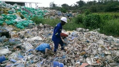 Didier sorts through plastic waste in Douala